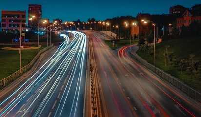 Lights of cars with night. Direction of traffic on the highway. 