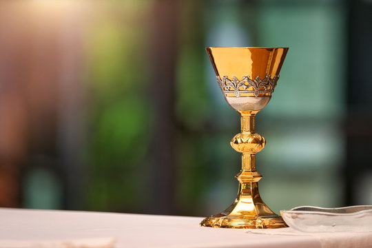 Chalice on the altar in church and empty space for text