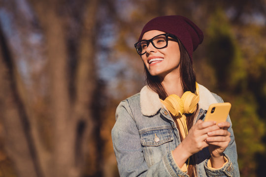 Close-up portrait of her she nice attractive pretty dreamy cheerful cheery girlfriend blogger using app 5g blogging spending free spare time hobby smm sunny day strolling outdoor outside fresh air - Powered by Adobe