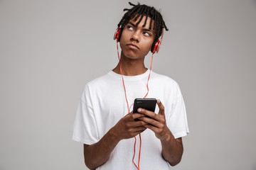 Young african man listening to music with headphones