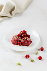 Raspberry ice cream from aquafaba with pistachios. Sugar, lactose, gluten free.