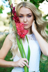 Naklejka premium Beautiful young woman with flower wreath and long hair. Blonde. Hair care. Summer. Bride