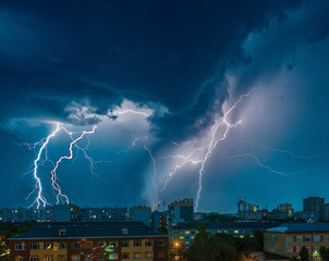 Naklejka na ściany i meble a strong thunderstorm with ligtnings over the city