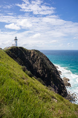 Lighthouse on a cliff by the sea. Vertical picture. Cape Byron. Byron Bay, New South Wales NSW,...