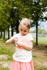 Cheerful girl inflates soap bubbles