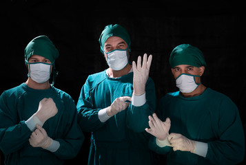 Fototapeta na wymiar Three doctor surgery team in the operating room. health care, reanimation and medicine concept. Hand of doctor in white glove.