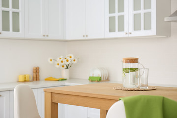 Stylish wooden table in beautiful kitchen interior