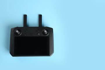 New modern drone controller on blue background, top view. Space for text