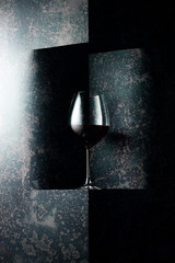 Glass of red wine on a dark background. Copy space.