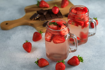 Strawberry drink and wooden board with chocolate. Diet strawberry drink