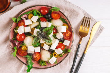  Italian salad with feta, olives, tomatoes, arugula and melon.