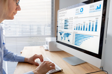 Manager analysing performance data on dashboard with KPI and metrics. Business analytics used in...