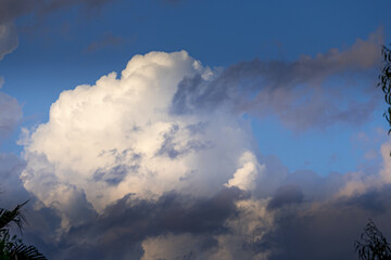 Blue sky with white and dark clouds.Heavenly dreamy fluffy colorful fantasy clouds.