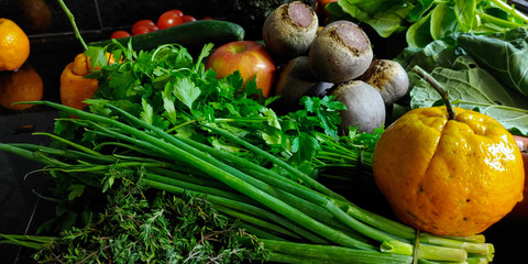 A small variety of fruits and vegetables that have just arrived from the organic fair.