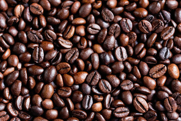 closeup of perfect Roasted coffee beans background. Food ingredients, top view, space for text. Soft selective focus.