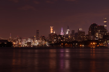 Nighttime Roosevelt Island and Manhattan Skyline along the East River in New York City