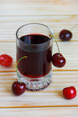 cherry drink in a glass and natural cherry fruits
