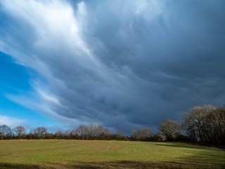 Fototapeta na wymiar storm clouds gathering over the farmland