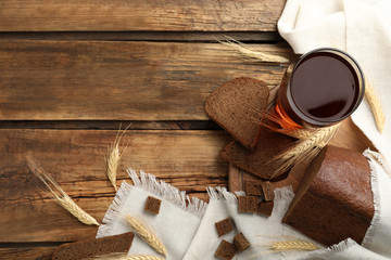 Flat lay composition with delicious kvass, spikes and bread on wooden table, space for text