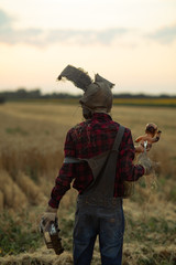 Man in image of sorcerer performs a voodoo ritual and holds doll impaled wire.
