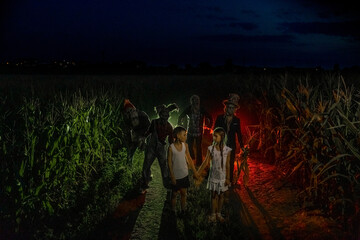 Children stand among of a cornfield near walking dead.