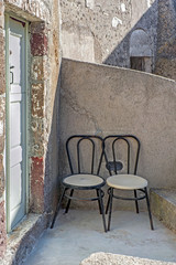 Two chairs on the terrace of Emporio, Santorini, Greece