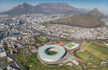Cape Town, Western Cape / South Africa - 07/24/2020: Aerial photo of Cape Town 2010 Stadium with Table Mountain in the background