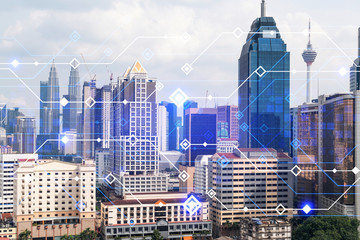 Technology hologram over panorama city view of Kuala Lumpur. KL is the largest tech hub in...
