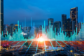 FOREX graph hologram, aerial night panoramic cityscape of Kuala Lumpur. KL is the developed location for stock market researchers in Malaysia, Asia. The concept of fundamental analysis.
