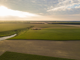 Fototapeta na wymiar Aerial view. Sunset over Ukrainian agricultural fields.