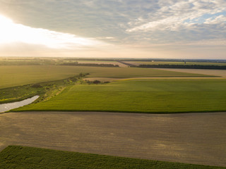 Aerial view. Sunset over Ukrainian agricultural fields.