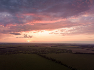 Aerial view. Sunset over Ukrainian agricultural fields.