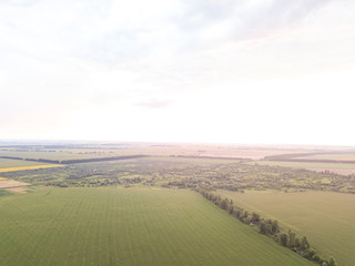 Aerial view. Sunset over Ukrainian agricultural fields.