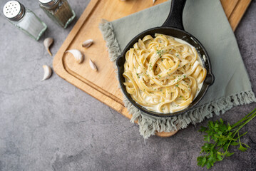 Alfredo pasta dinner with creamy white sauce and herbs - obrazy, fototapety, plakaty