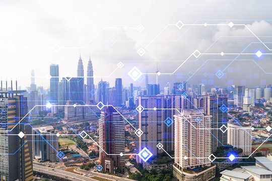 Technology hologram over panorama city view of Kuala Lumpur. KL is the largest tech hub in Malaysia, Asia. The concept of developing coding and high-tech science. Double exposure.