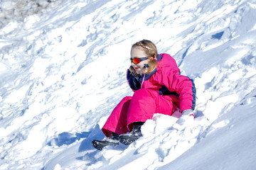 Fototapeta na wymiar Young Girl Glides Down On The Snow Mountain.