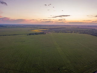 Aerial view. Sunset over Ukrainian agricultural fields.