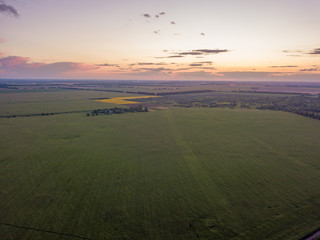 Aerial view. Sunset over Ukrainian agricultural fields.