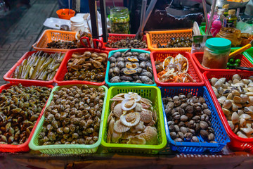 Seafood on the counter and Snail's for sale in a night market in Ho Chi Minh city (Saigon), Vietnam.