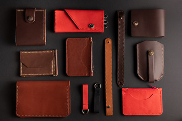 set of leather items made by hands on a black background. view from above. flat lay. Leather craft concept.
