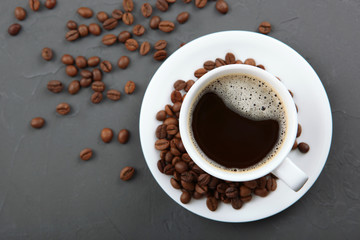 coffee beans and coffee cup on colored background with place for text
