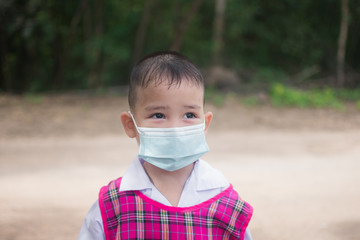 cute little boy wear mask for protection coronavirus or covid 19. subject is blurred.