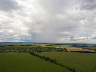 Fototapeta na wymiar Aerial drone view. Rain clouds over the Ukrainian field. It is raining.