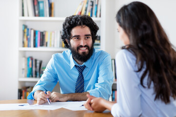 Arabic businessman at job interview with indian trainee