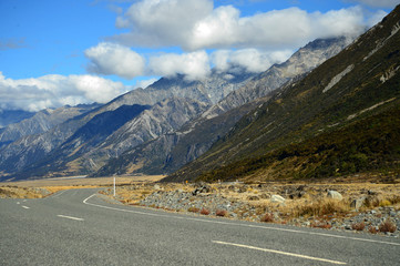 Straight road leading towards a snow capped mountain in New Zealand