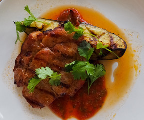 photo of pork steak with tomato sauce and fried eggplant