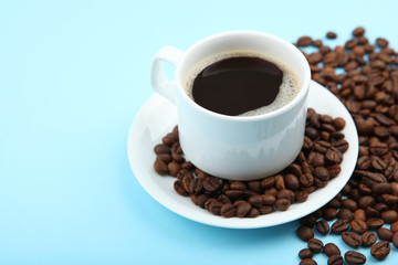 coffee beans and coffee cup on colored background with place for text

