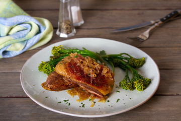 Duck breast fillets with caramelized onion and broccoli