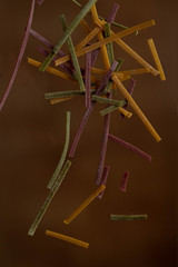 Dry pasta of different colors, yellow with turmeric, pink with storm, green with spinach, Italian cuisine, telanatelle