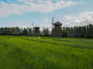 photo of a large field next to a river above a cloudy sky